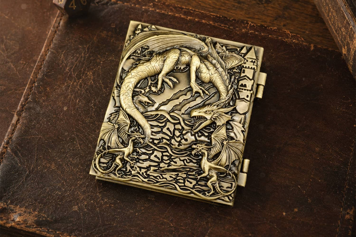 A closed antique bronze Dice Codex with a sculpted dragon cover.