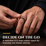 Person wearing and spinning the D12 magnetic decision ring for choices on the go.