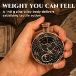 Hand holding a 140 g antique copper pocket press dice with raised dragon relief.