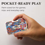 Hand holding a colorful joker mechanical dice card to show its pocket-ready size.