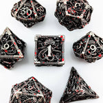 Top view of the silver hollow metal RPG dice set with red splatter accents.